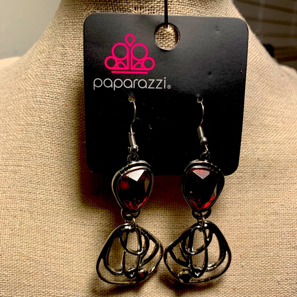 Beautiful silver earrings with shinny red rhinestones .